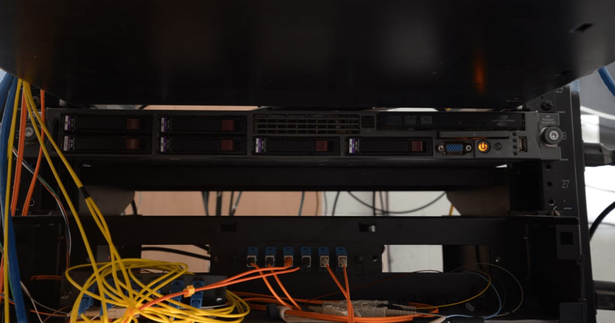 A server rack with hard drives and network cables in a data center